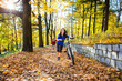 Urban biking - teens riding bikes in city park