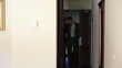 Businessman with suitcase walk into the hotel room