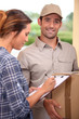 Woman signing for parcel