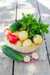 Fresh young potatoes , cucumbers , radishes and herbs