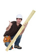 Photo: Male carpenter showing direction. Male carpenter showing direction.