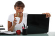 Business woman drinking at desk