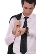 Businessman checking his watch for the time