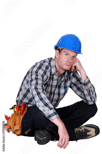 Photo: Bored builder sat on the floor Bored builder sat on the floor