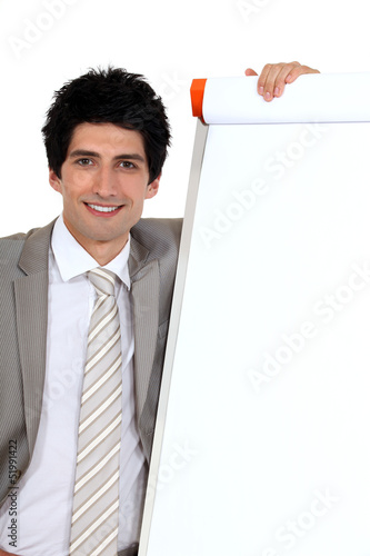 Photo: businessman posing next to a blank board businessman posing next to a blank board