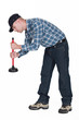 Foto: Plumber using plunger isolated on white background Plumber using plunger isolated on white background