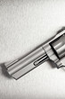Gun on brushed metal background
