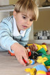 Foto: Little blond boy playing with toys Little blond boy playing with toys
