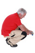 Photo: Man using pliers Man using pliers