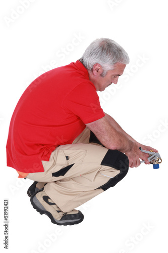 Photo: Man using pliers Man using pliers