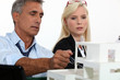 Architects examining a model
