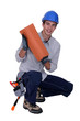 Craftsman crouching with tile