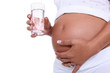 Foto: Pregnant woman holding a glass of water Pregnant woman holding a glass of water