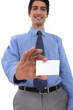 Businessman showing his business card.