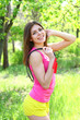 Happy girl posing with a skipping rope on the background of tree