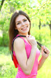 Smiling girl posing with a skipping rope on a hot summer day