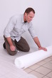 Laborer changing tiles