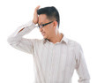 Asian business man holding his head. Conceptual image.