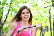 Young woman posing with a skipping rope in a summer park