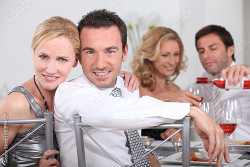 Photo: Couple dining with friends Couple dining with friends