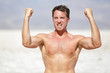 Fitness man showing muscles cheering outside