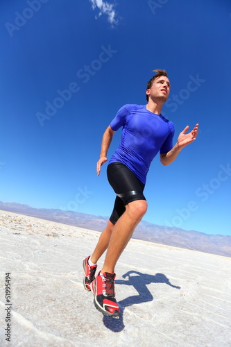 Photo: Running sport athlete man sprinting in trail run Running sport athlete man sprinting in trail run
