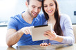 Couple using digital tablet