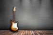 Raum mit Holzboden, Ziegelwand und E-Gitarre sunburst