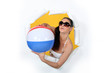 Woman with beach ball coming out of hole