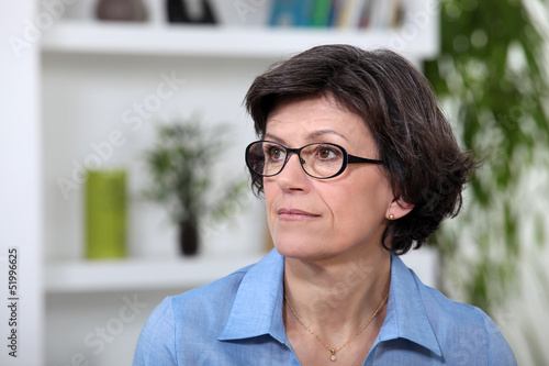 Photo: A portrait of a middle age woman in her living room. A portrait of a middle age woman in her living room.