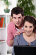 Photo: young couple home with laptop young couple home with laptop