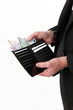 Photo: Businessman pulling out a wad of money from his wallet Businessman pulling out a wad of money from his wallet