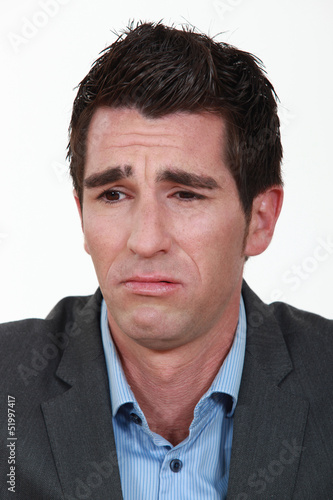 Photo: A businessman frowning. A businessman frowning.