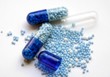 blue capsules with granulated potassium medicine