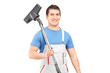 A young male worker holding a vacuum cleaner