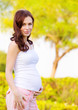 Expectant woman in spring park