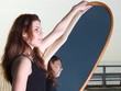 thoughtful woman looks at the reflection in mirror