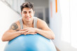 Smiling man with blue gym ball