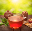 glass cup of tea on sunny natural background
