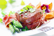 Thick juicy steak with fresh green asparagus