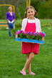 Gardening, planting - girl helping mother in the garden