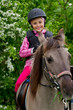 Photo: Horse riding - lovely girl is riding on a horse Horse riding - lovely girl is riding on a horse