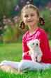 Friends - Happy girl with cute puppy in the garden
