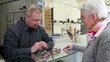 Optician selling glasses to senior woman