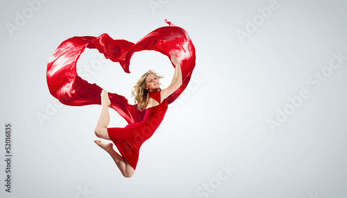 Photo: Dancing young woman with flying fabric Dancing young woman with flying fabric