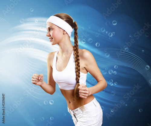 Photo: Young pretty woman in sport wear running Young pretty woman in sport wear running
