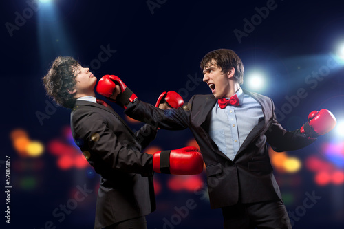 Photo: Two young businessman boxing Two young businessman boxing