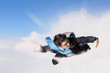 Young businessman flying with parachute on back