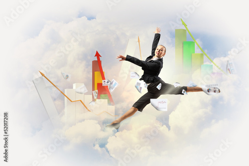 Photo: businesswoman in black suit jumping businesswoman in black suit jumping