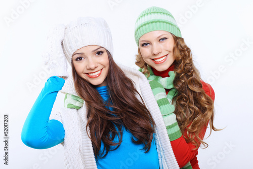 Photo: Young woman wearing winter hat and warm scarf Young woman wearing winter hat and warm scarf